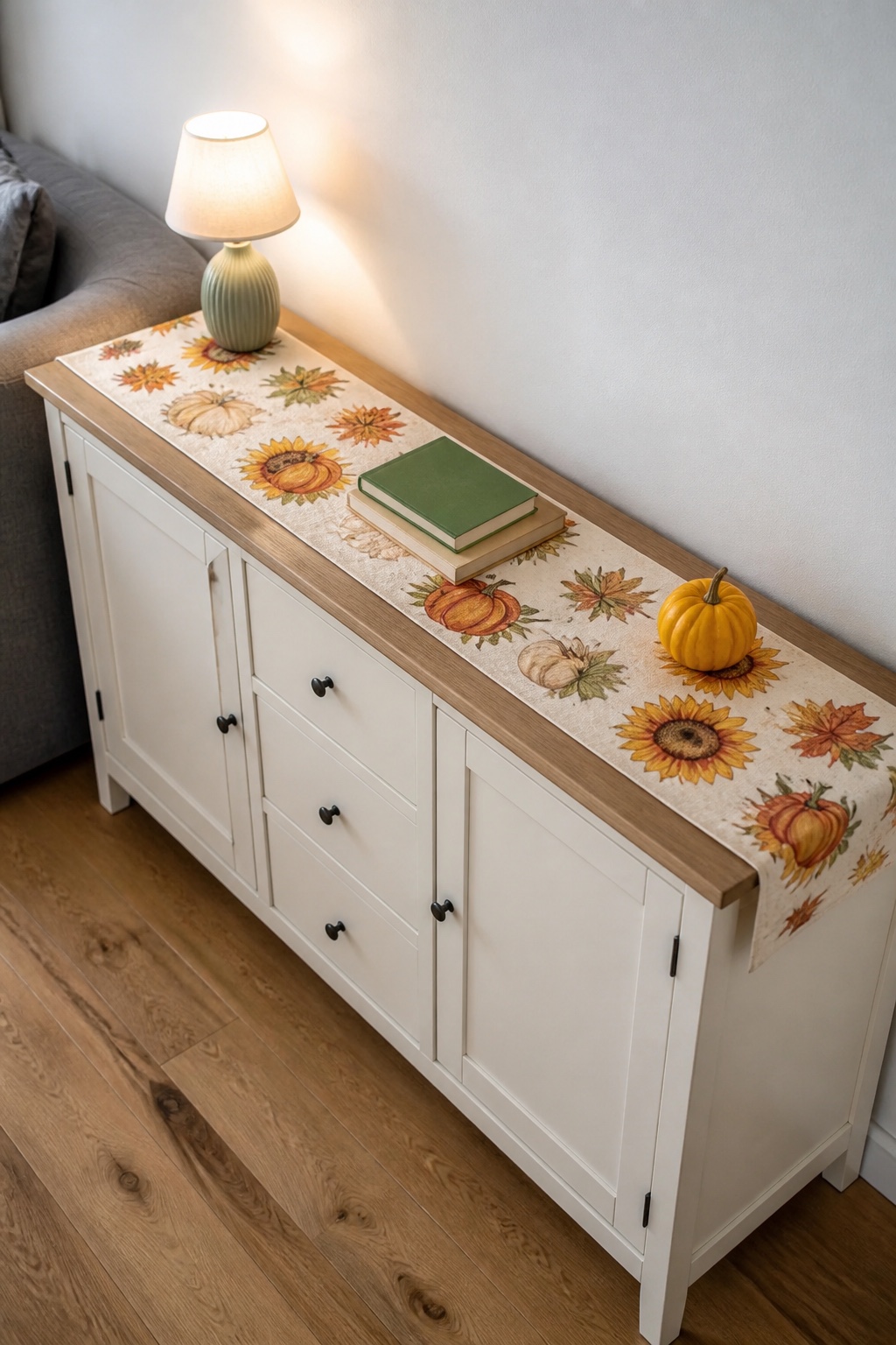 Herbstlicher Tischläufer auf einem schmalen Sideboard